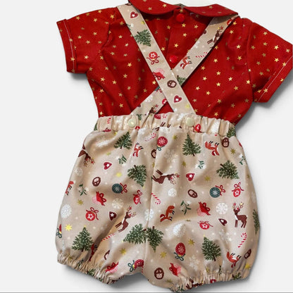 A baby romper set featuring a red short-sleeve top with gold stars and matching red bib with beige suspenders printed with a Christmas theme on a light gray background.